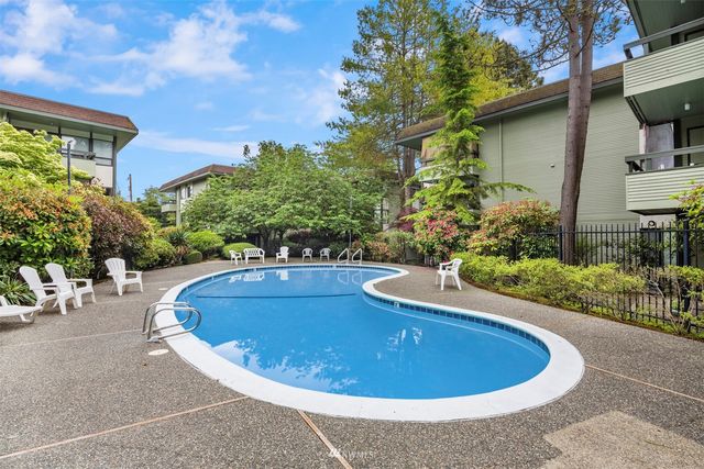 a view of a swimming pool with an outdoor seating