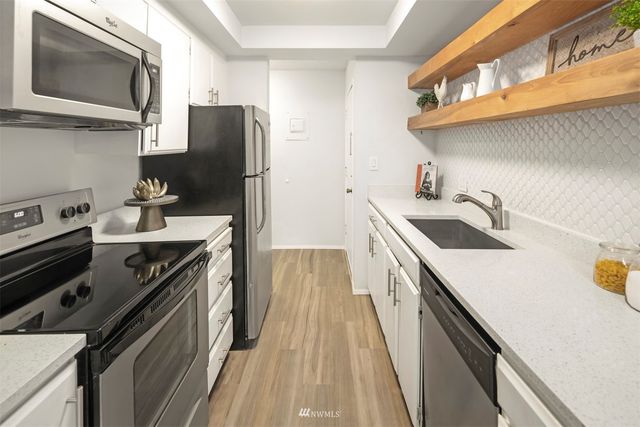 a kitchen with a sink stove and refrigerator