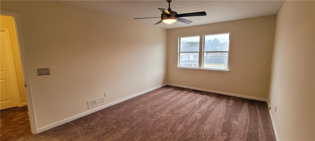 2082 Montgomery Trail Duluth, GA 30096 - Photo 21 of 31 a view of an empty room with wooden floor and a window
