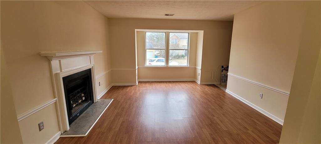 2082 Montgomery Trail Duluth, GA 30096 - Photo 6 of 31 a view of a livingroom with wooden floor and a window