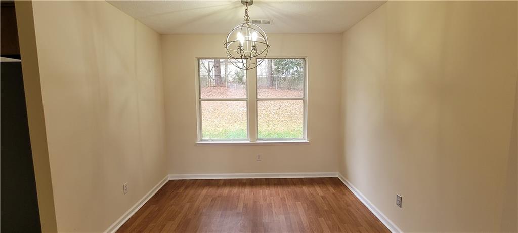 2082 Montgomery Trail Duluth, GA 30096 - Photo 9 of 31 an empty room with wooden floor and windows