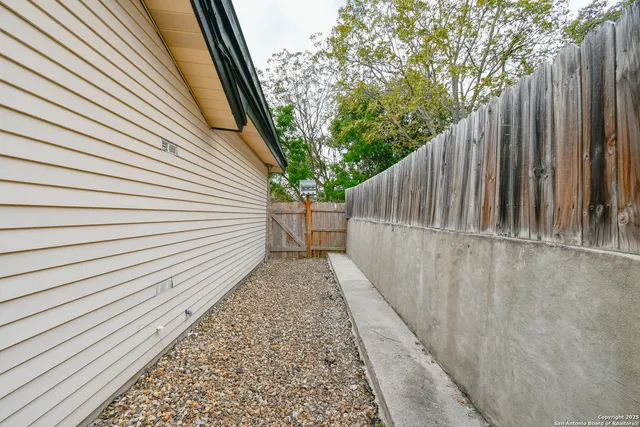 a view of empty room with wooden floor and ceiling fan