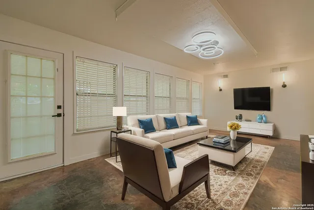a living room with furniture and a flat screen tv