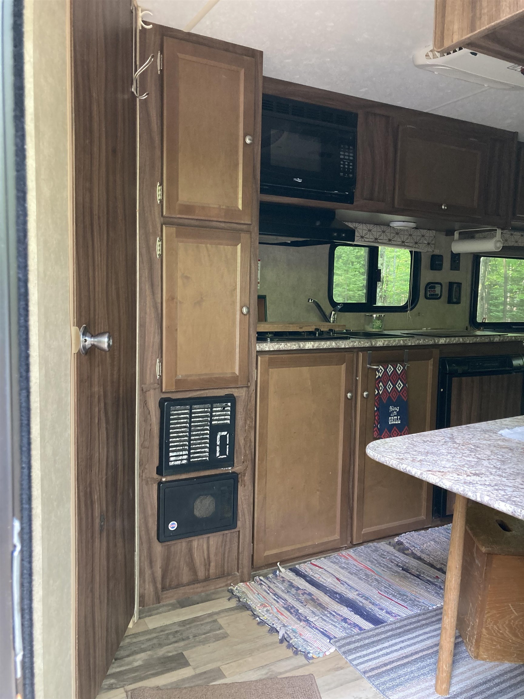 14334 East Eagle Ridge Brule, WI 54820 - Photo 9 of 26 Kitchen featuring black microwave, wood finished floors, a sink, and light stone countertops