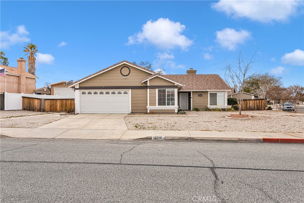 13246 Snowview Road Victorville, CA 92392 - Photo 1 of 1 a front view of a house with a yard