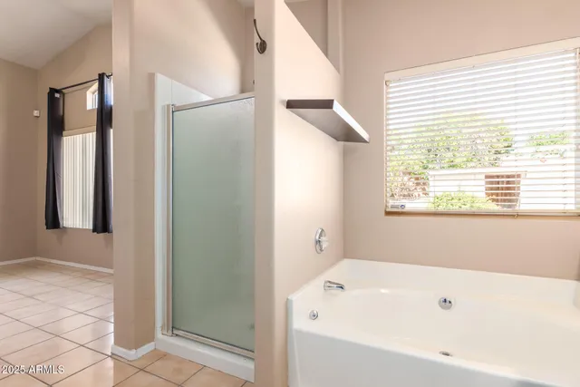 a bathroom with a bathtub and shower