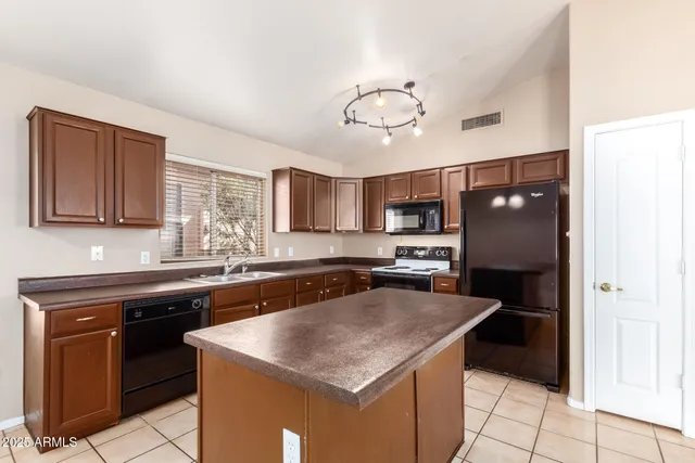 a kitchen with a sink a stove and cabinets