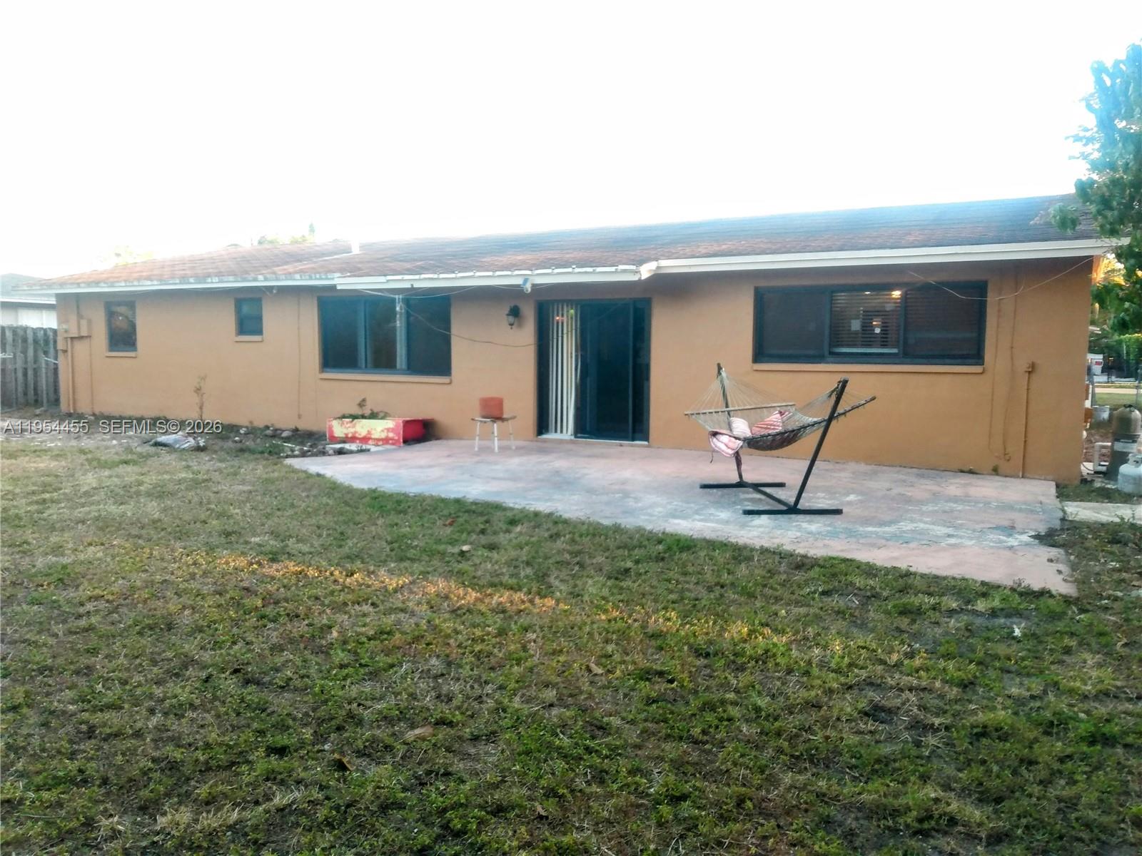 4411 Northwest 15th Street Lauderhill, FL 33313 - Photo 12 of 14 a backyard of a house with table and chairs