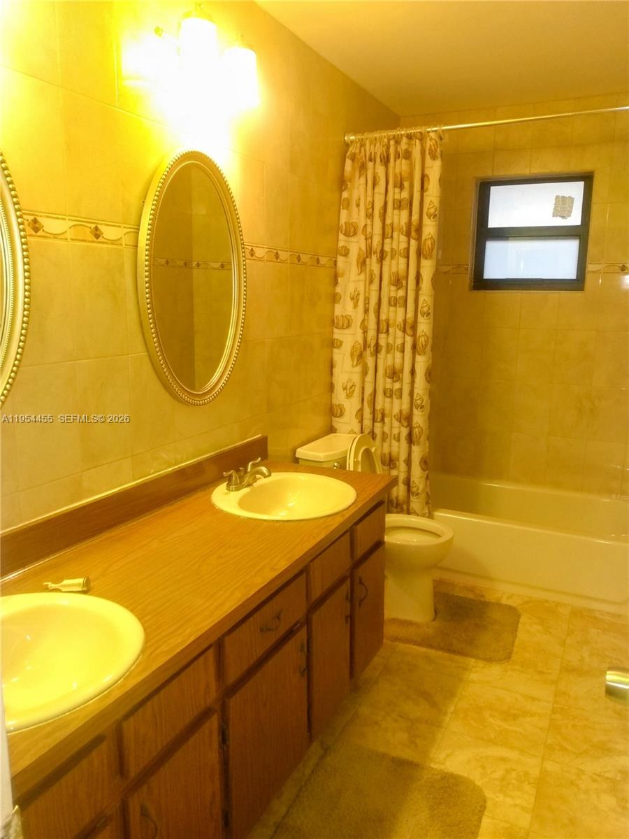 4411 Northwest 15th Street Lauderhill, FL 33313 - Photo 8 of 14 a bathroom with a sink and a mirror