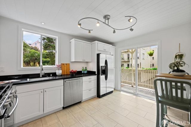 a kitchen with stainless steel appliances granite countertop a stove and a sink