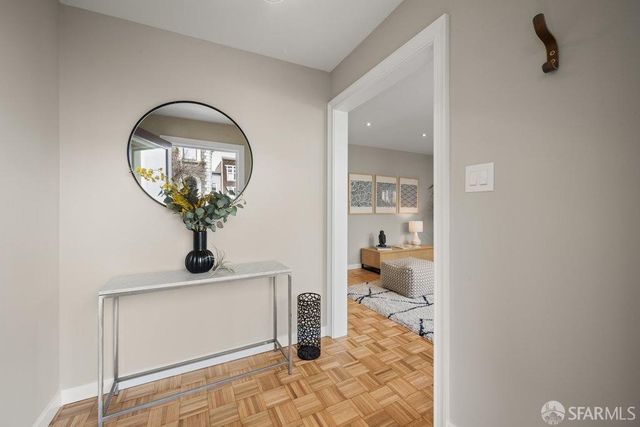 a living room with furniture wooden floor and a large window
