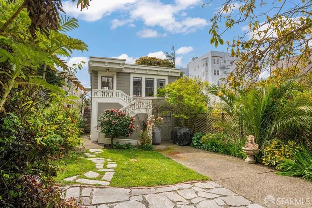 an aerial view of multiple houses with a yard