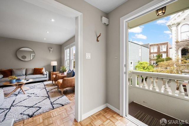 a living room with furniture or couch and a large window