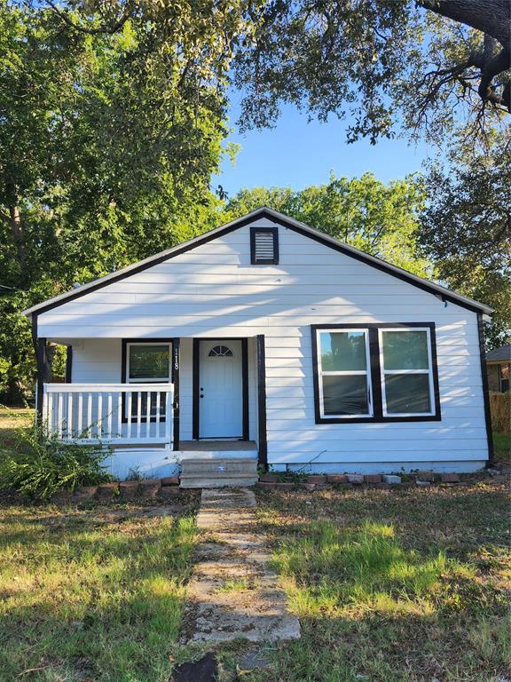 1118 East Oak Street Denton, TX 76205 - Photo 2 of 9 a front view of a house with garden