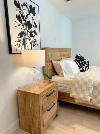 a bedroom with a bed and a painting on the wall