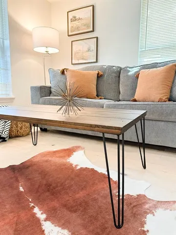 a living room with furniture and a rug