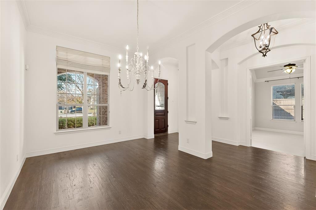 11048 Riney Court Frisco, TX 75035 - Photo 15 of 40 a view of a big room with wooden floor chandeliers and kitchen view