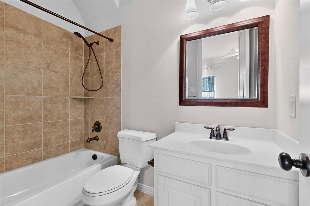 11048 Riney Court Frisco, TX 75035 - Photo 22 of 40 a bathroom with a toilet sink shower and mirror