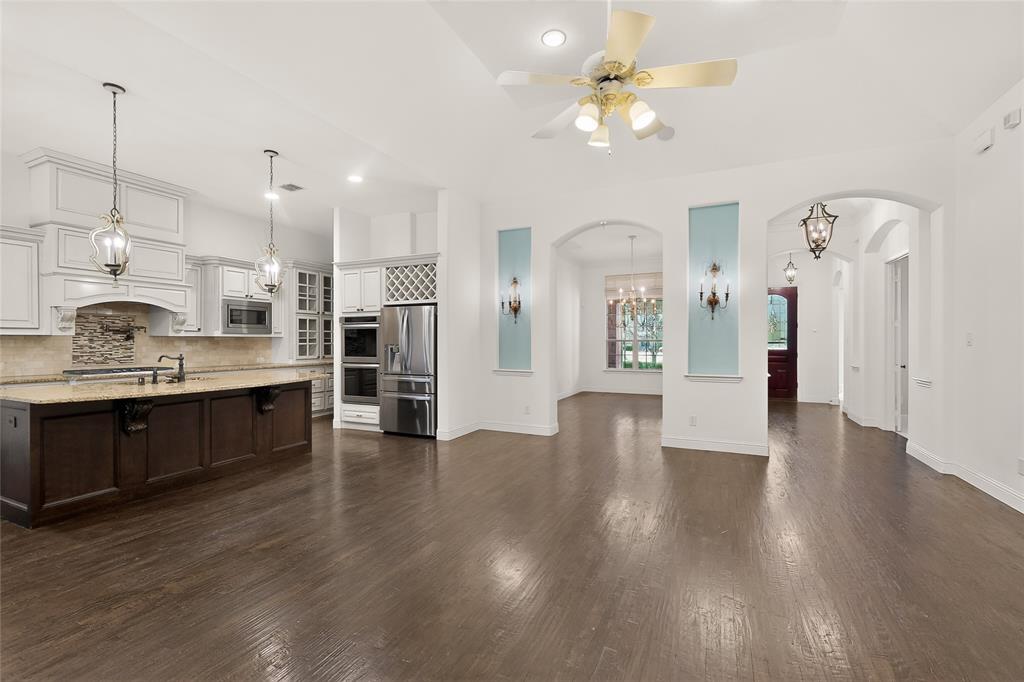 11048 Riney Court Frisco, TX 75035 - Photo 8 of 40 a view of a kitchen with wooden floor and a kitchen view