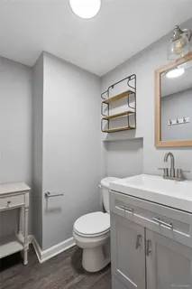 a bathroom with a toilet a sink and mirror