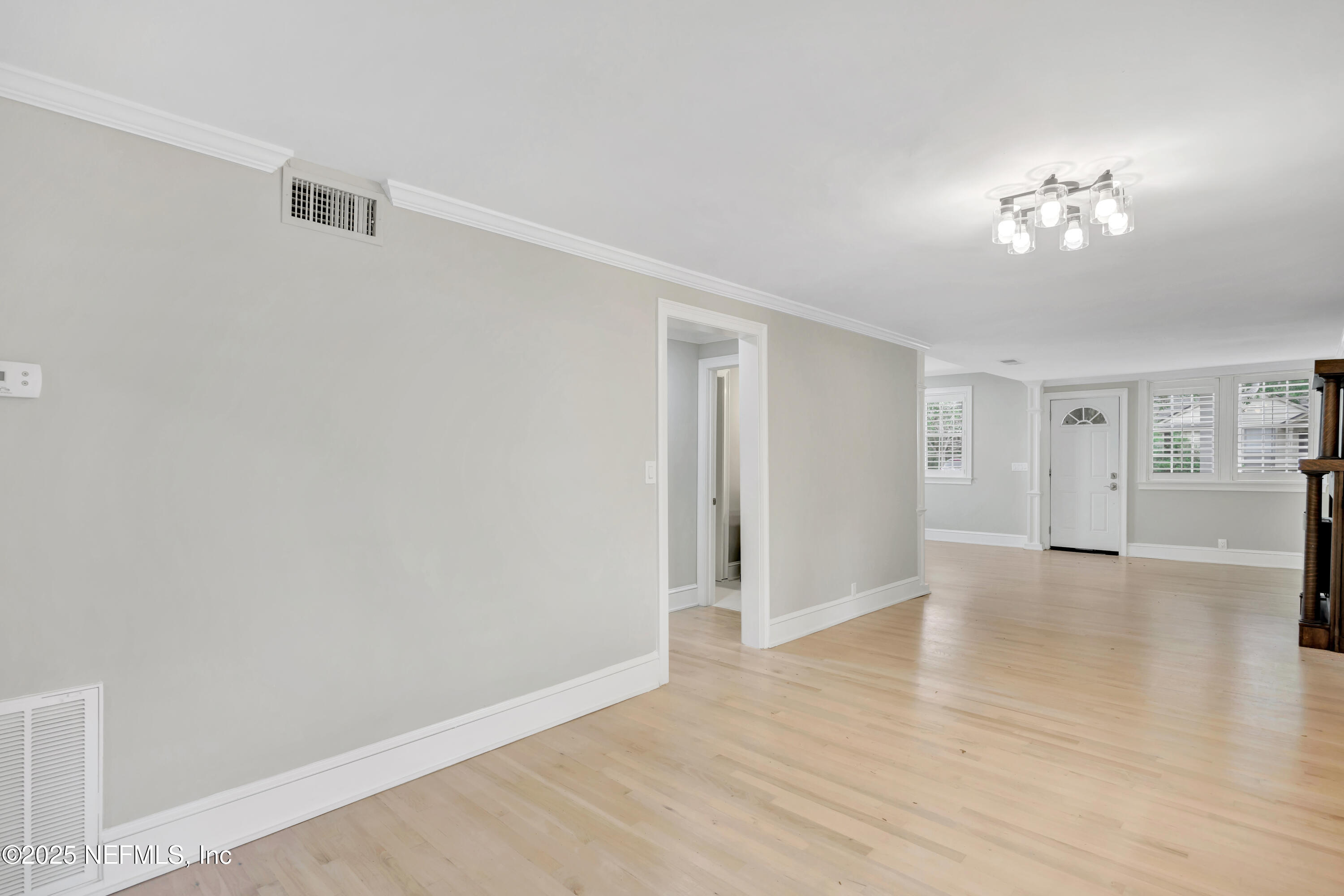 1210 Inwood Terrace Jacksonville, FL 32207 - Photo 17 of 48 a view of an empty room with wooden floor and a window