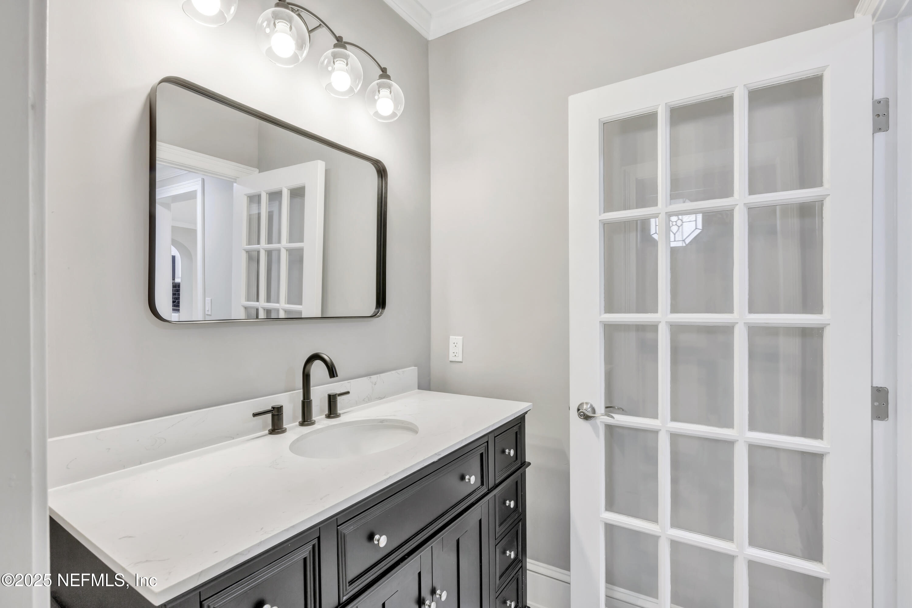 1210 Inwood Terrace Jacksonville, FL 32207 - Photo 32 of 48 a bathroom with a sink vanity and a mirror