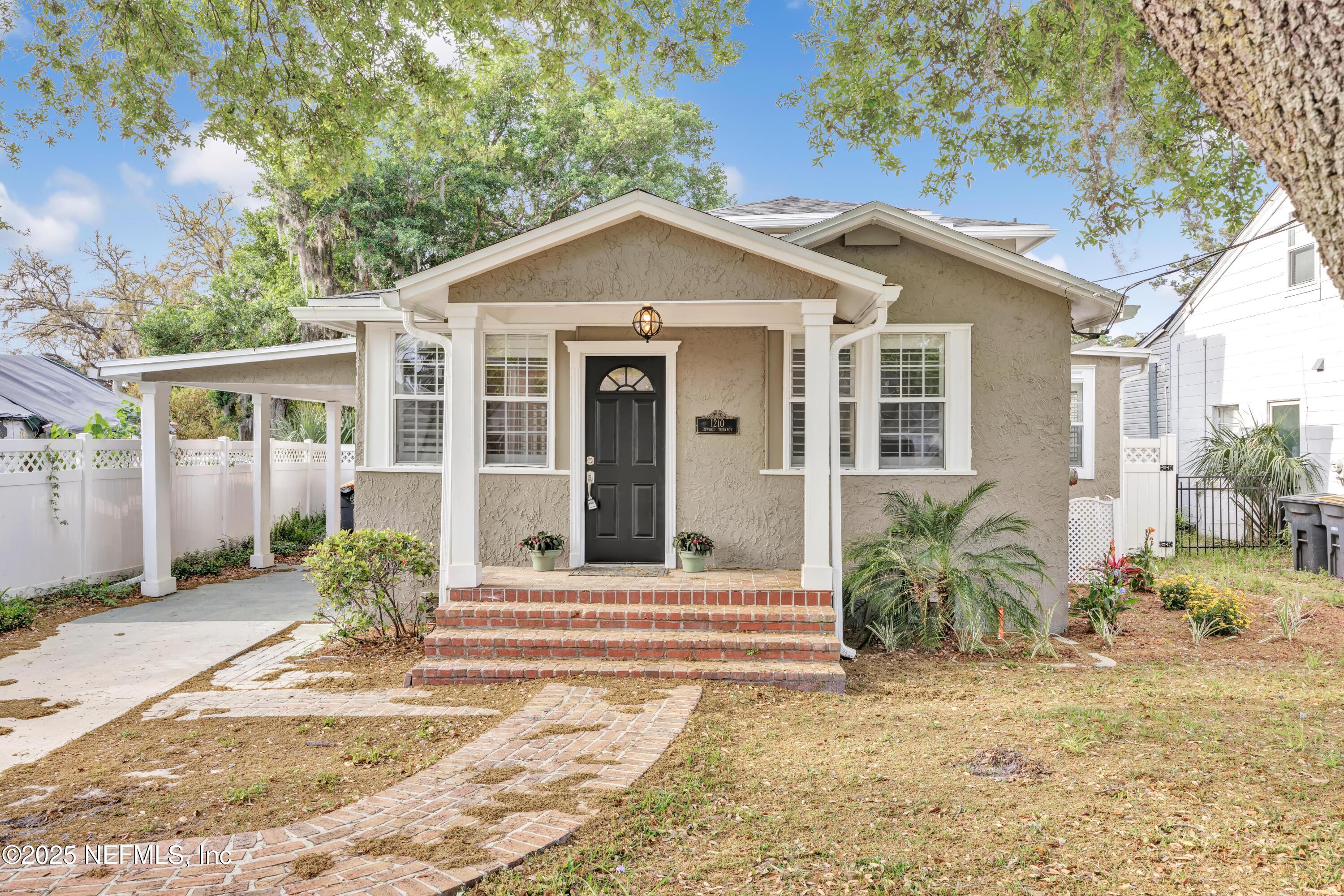 1210 Inwood Terrace Jacksonville, FL 32207 - Photo 34 of 48 a view of a house with a small yard plants and large tree