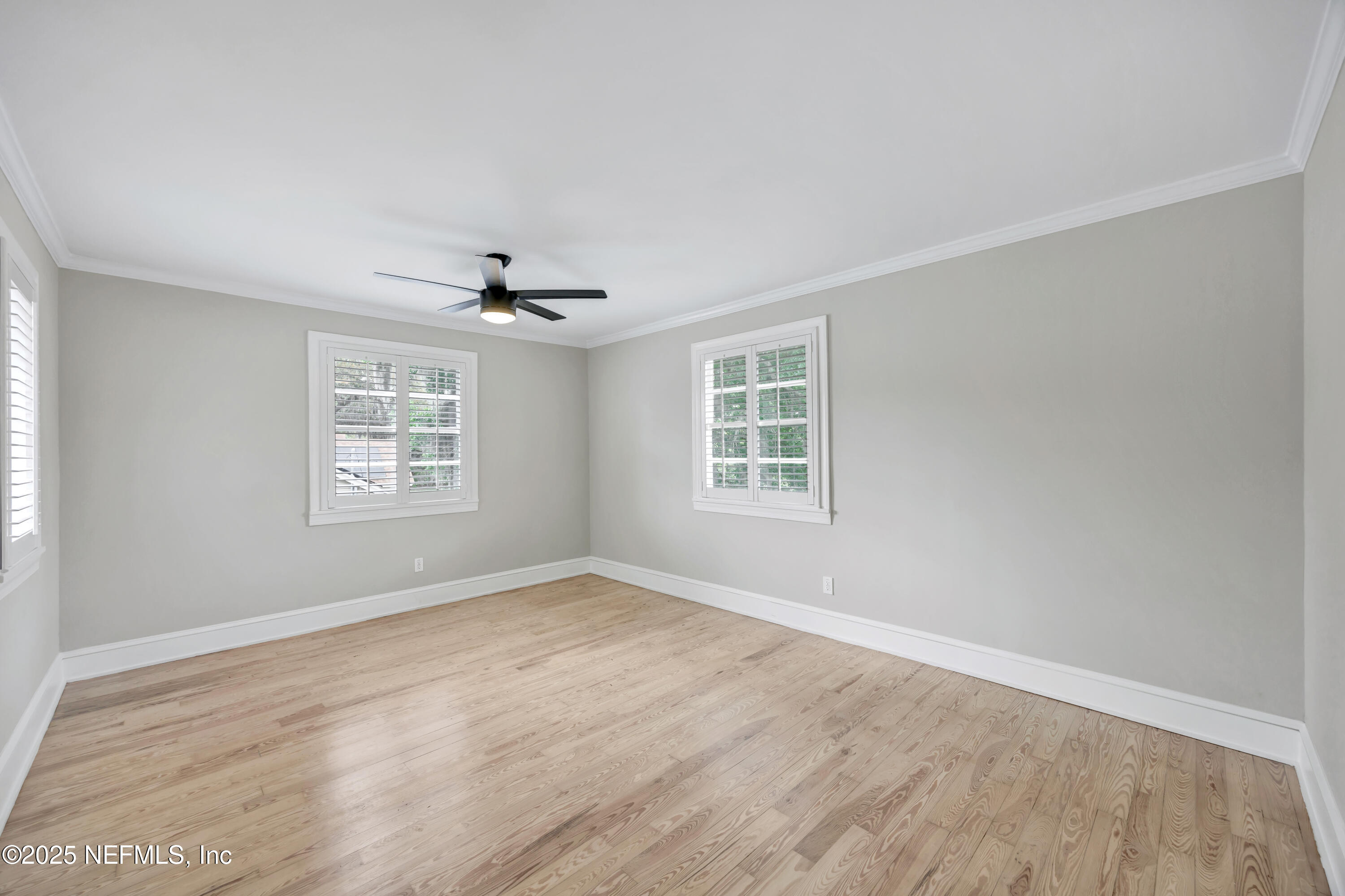1210 Inwood Terrace Jacksonville, FL 32207 - Photo 48 of 48 an empty room with windows and ceiling fan