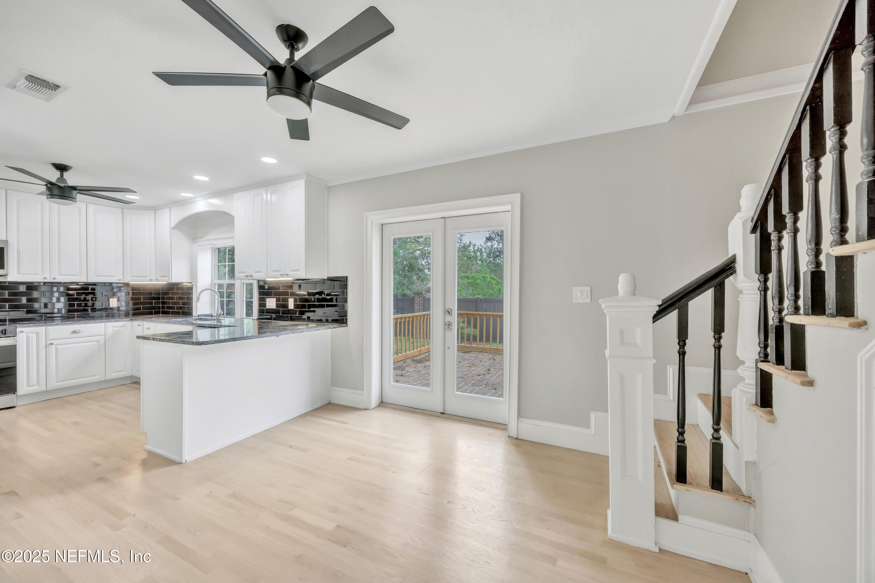 1210 Inwood Terrace Jacksonville, FL 32207 - Photo 5 of 48 a large white kitchen with stainless steel appliances kitchen island granite countertop a refrigerator a stove a sink and a large window