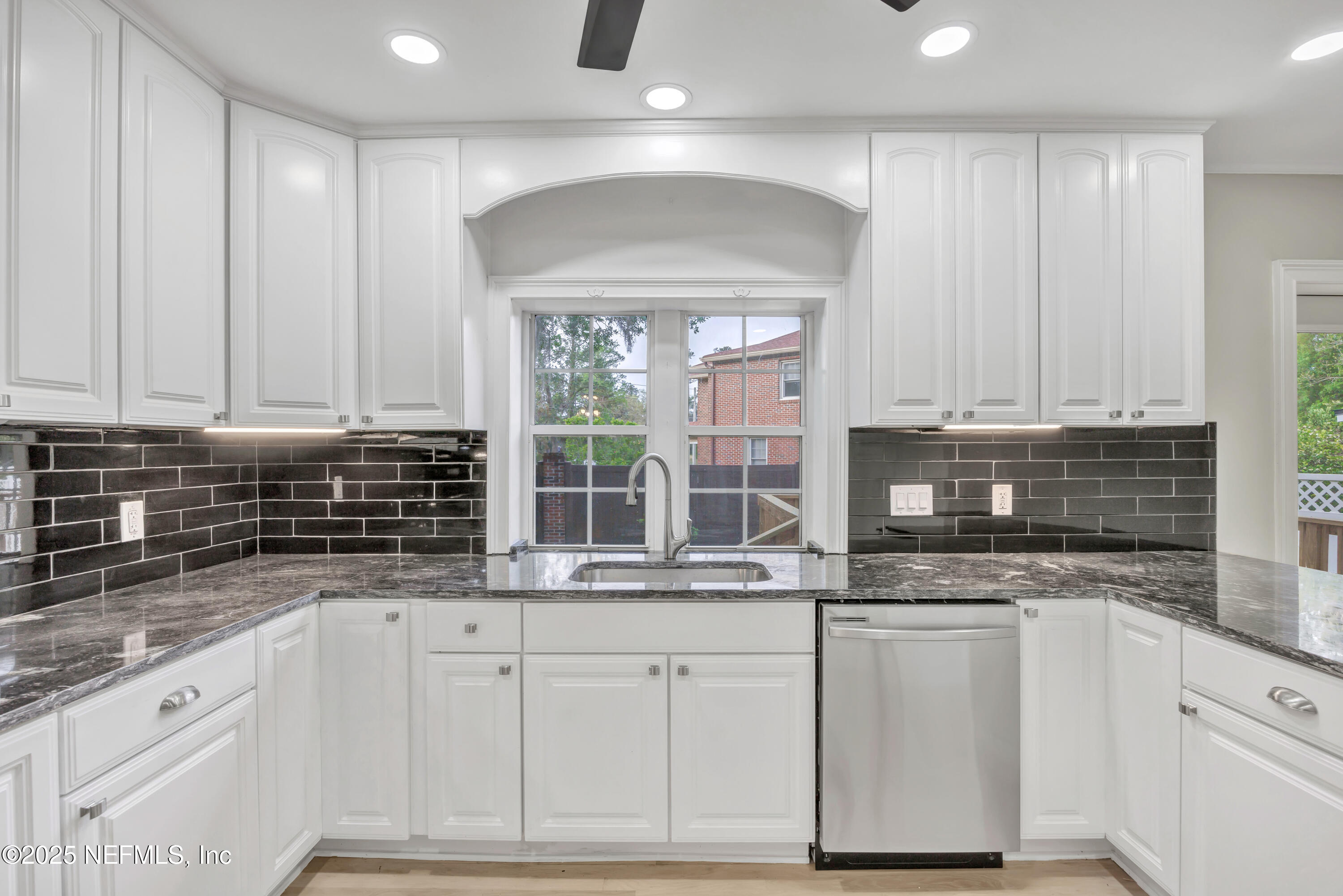 1210 Inwood Terrace Jacksonville, FL 32207 - Photo 6 of 48 a kitchen with granite countertop white cabinets and white appliances
