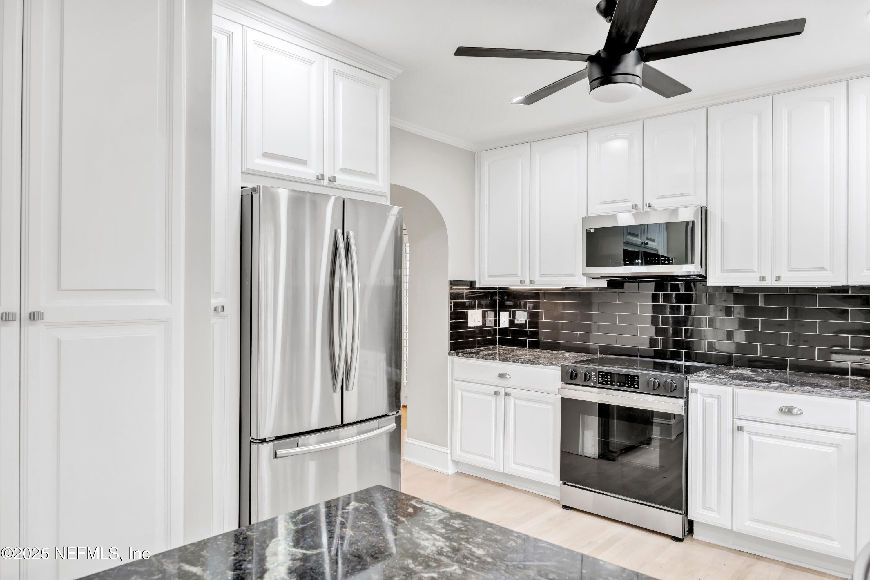 1210 Inwood Terrace Jacksonville, FL 32207 - Photo 7 of 48 a kitchen with stainless steel appliances white cabinets and a stove