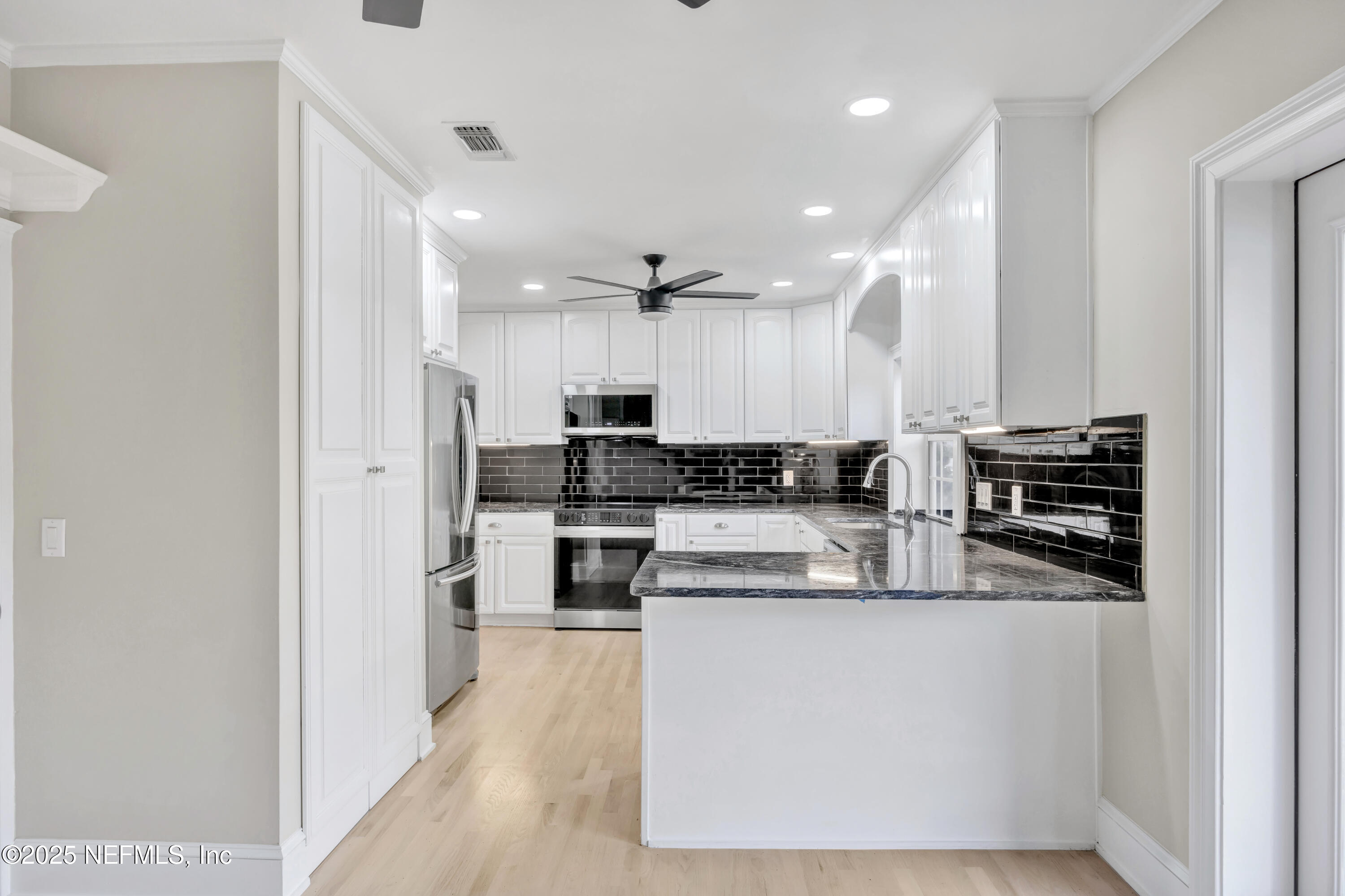 1210 Inwood Terrace Jacksonville, FL 32207 - Photo 10 of 48 a kitchen with stainless steel appliances kitchen island a stove a sink and a refrigerator