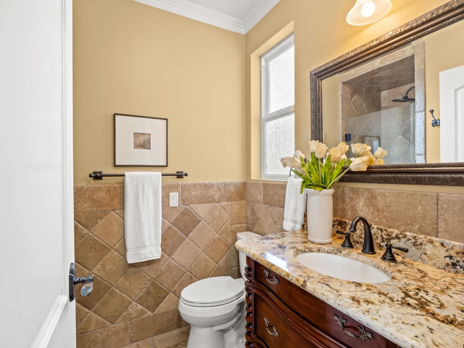 17113 Mark Road Madera, CA 93636 - Photo 28 of 99 a bathroom with a granite countertop sink a toilet and a mirror
