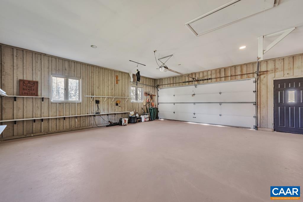 304 Club Road Louisa, VA 23093 - Photo 34 of 55 2 Car Garage with shelving, closet and still plenty of trash can storage.