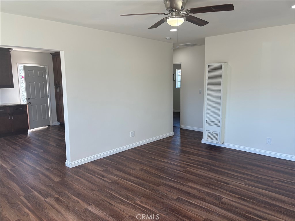 7563 Lincoln Avenue Riverside, CA 92504 - Photo 11 of 34 an empty room with wooden floor and entryway