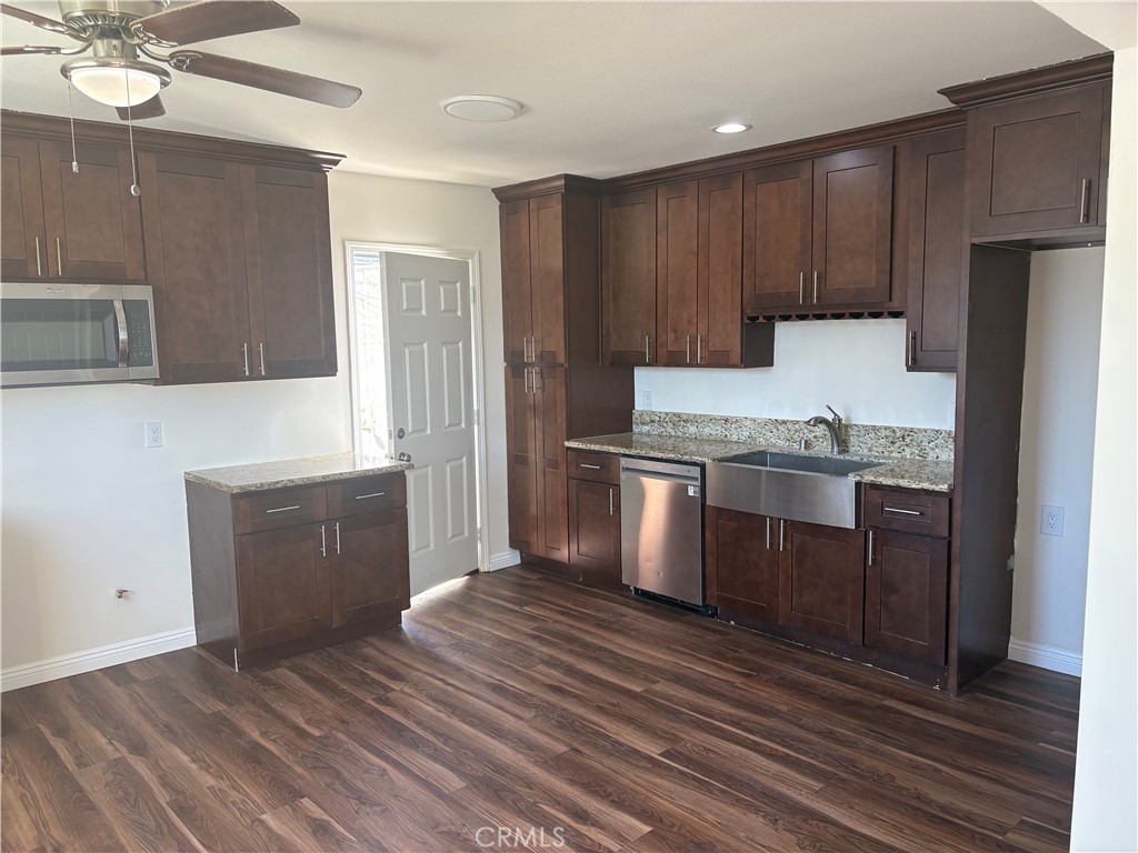 7563 Lincoln Avenue Riverside, CA 92504 - Photo 12 of 34 a kitchen with granite countertop a refrigerator and a sink