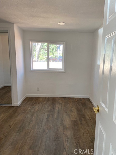 7563 Lincoln Avenue Riverside, CA 92504 - Photo 18 of 34 an empty room with wooden floor and windows