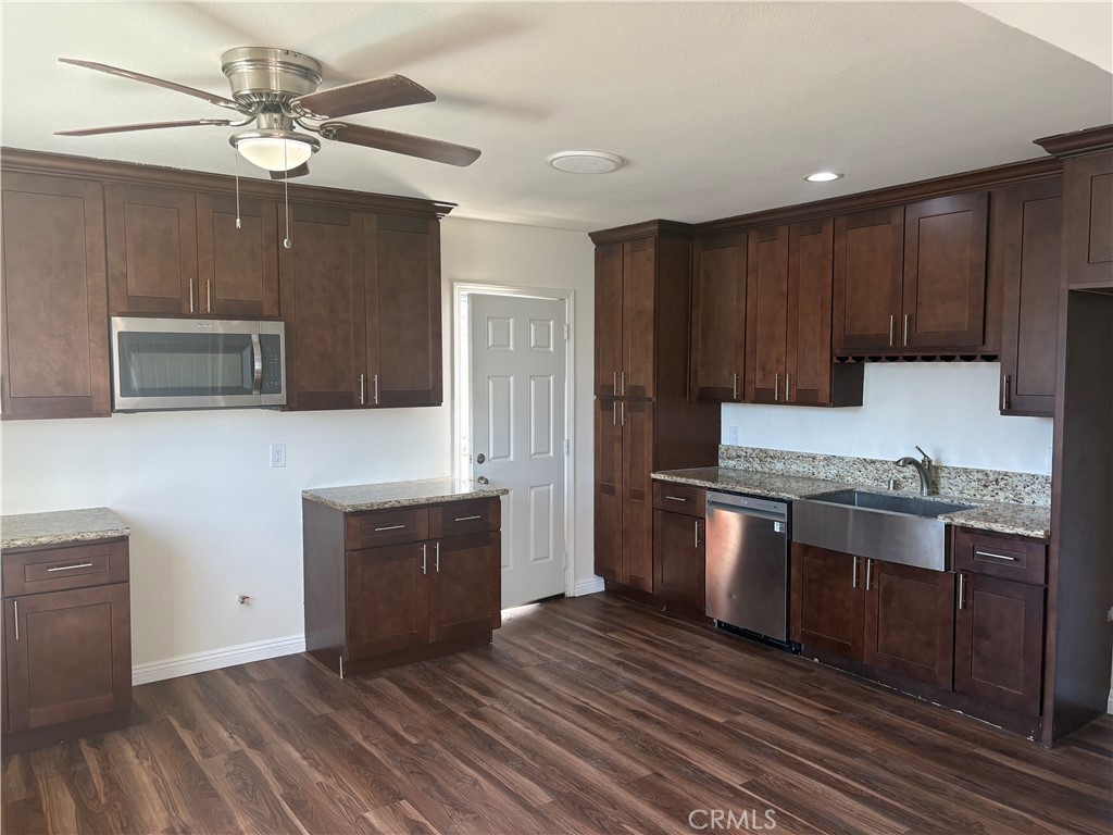 7563 Lincoln Avenue Riverside, CA 92504 - Photo 2 of 34 a kitchen with stainless steel appliances granite countertop a stove a sink and a microwave