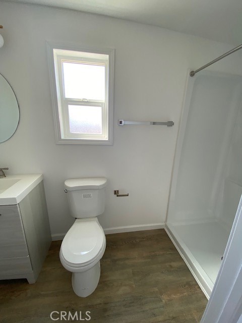 7563 Lincoln Avenue Riverside, CA 92504 - Photo 23 of 34 a white toilet sitting next to a bathroom sink