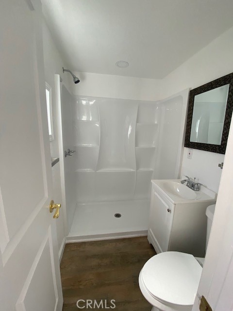 7563 Lincoln Avenue Riverside, CA 92504 - Photo 25 of 34 a white toilet sitting next to a bathroom sink
