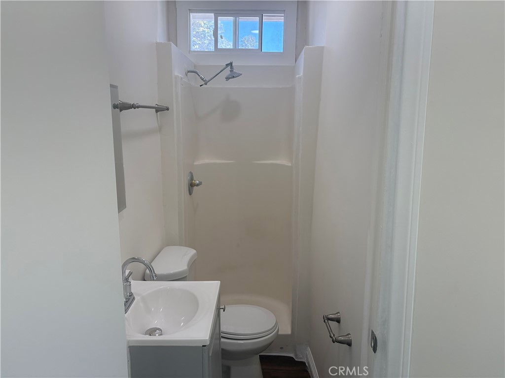 7563 Lincoln Avenue Riverside, CA 92504 - Photo 5 of 34 a white toilet sitting next to a shower
