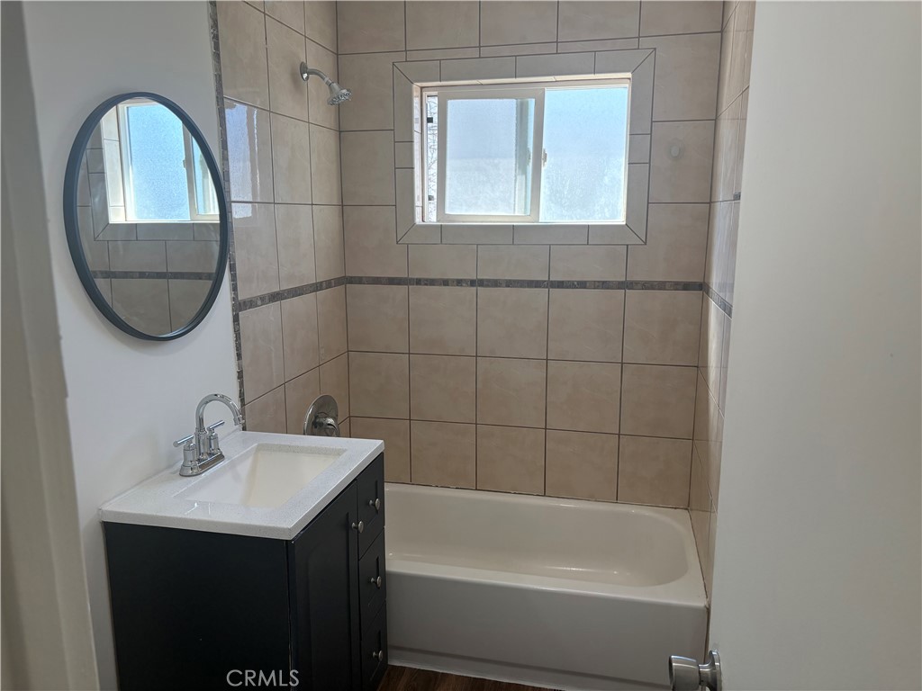 7563 Lincoln Avenue Riverside, CA 92504 - Photo 7 of 34 a bathroom with a sink a window and a mirror