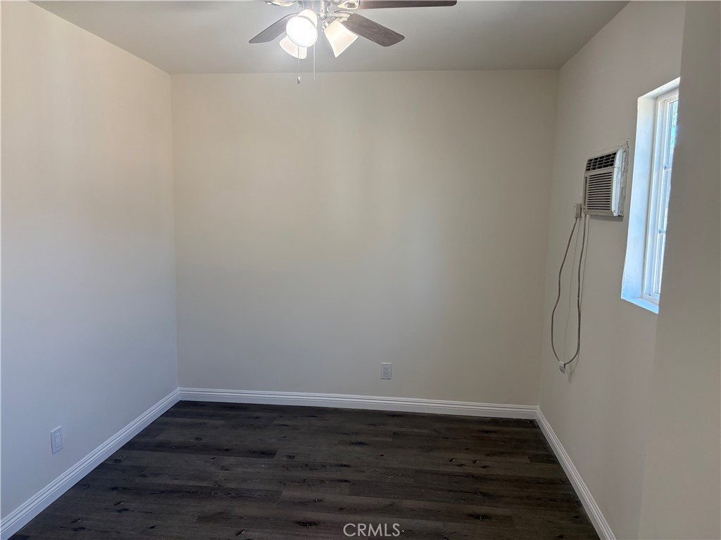 7563 Lincoln Avenue Riverside, CA 92504 - Photo 8 of 34 a view of an empty room with wooden floor and fan