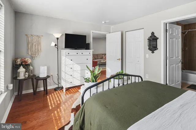 a bed sitting in a bedroom and flat screen tv