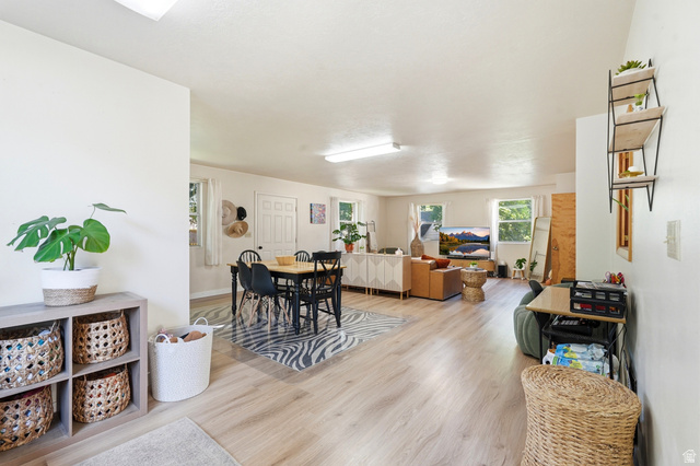 270 East 700 North Logan, UT 84321 - Photo 5 of 42 Open-concept living space featuring wood-finish flooring, white walls, and multiple windows