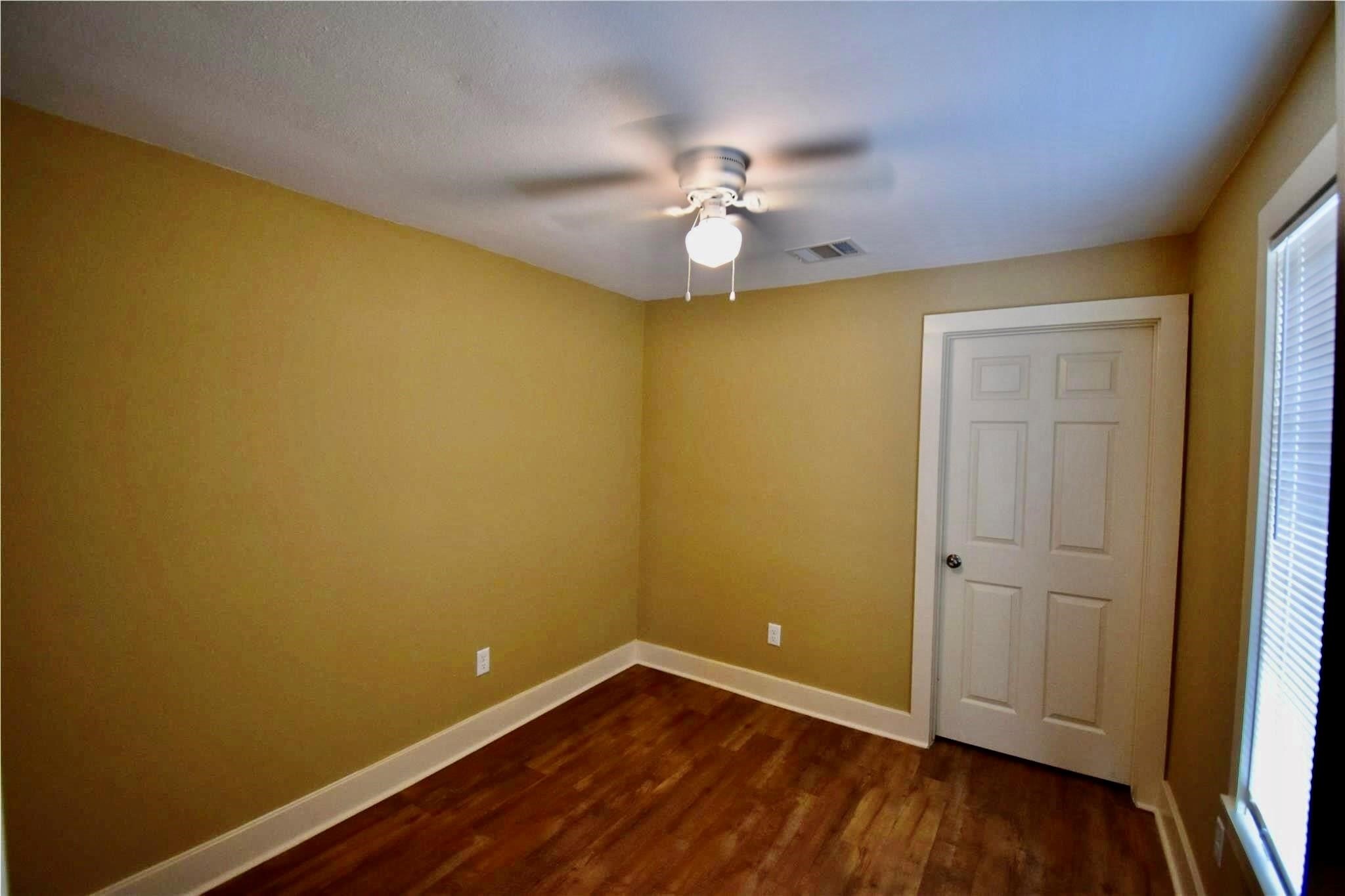 321 East 35th Street Houston, TX 77018 - Photo 7 of 10 an empty room with wooden floor and fan