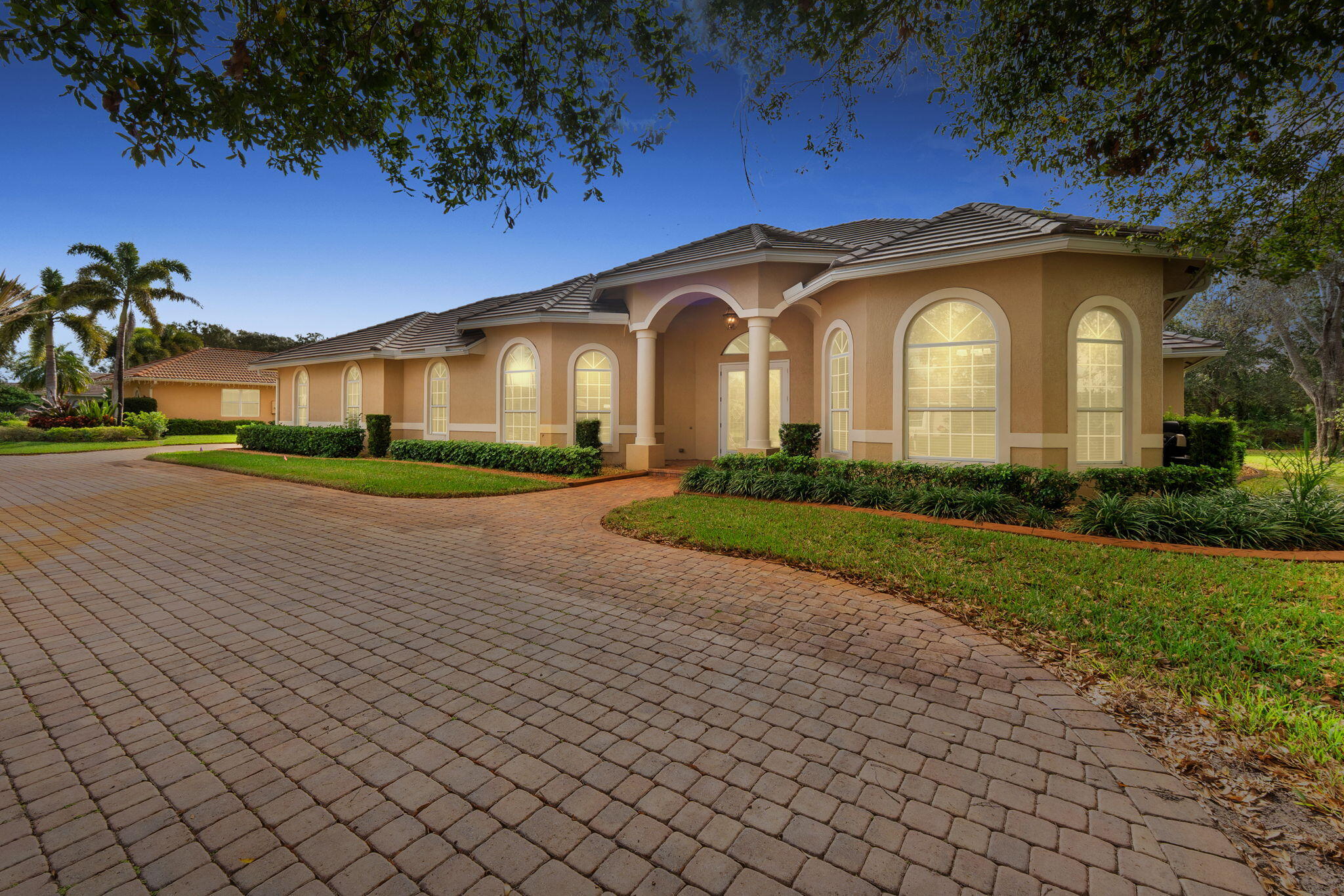 9523 Shadow Lane Fort Pierce, FL 34951 - Photo 1 of 32 a front view of a house with a garden and trees