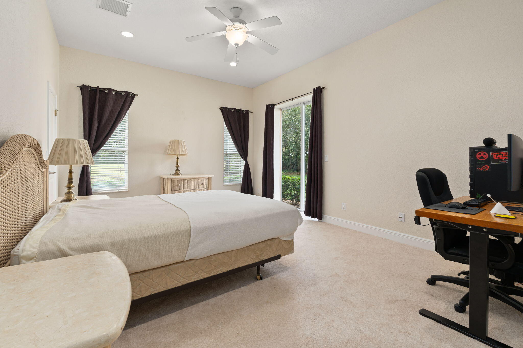 9523 Shadow Lane Fort Pierce, FL 34951 - Photo 27 of 32 a bedroom with a large bed and a desk
