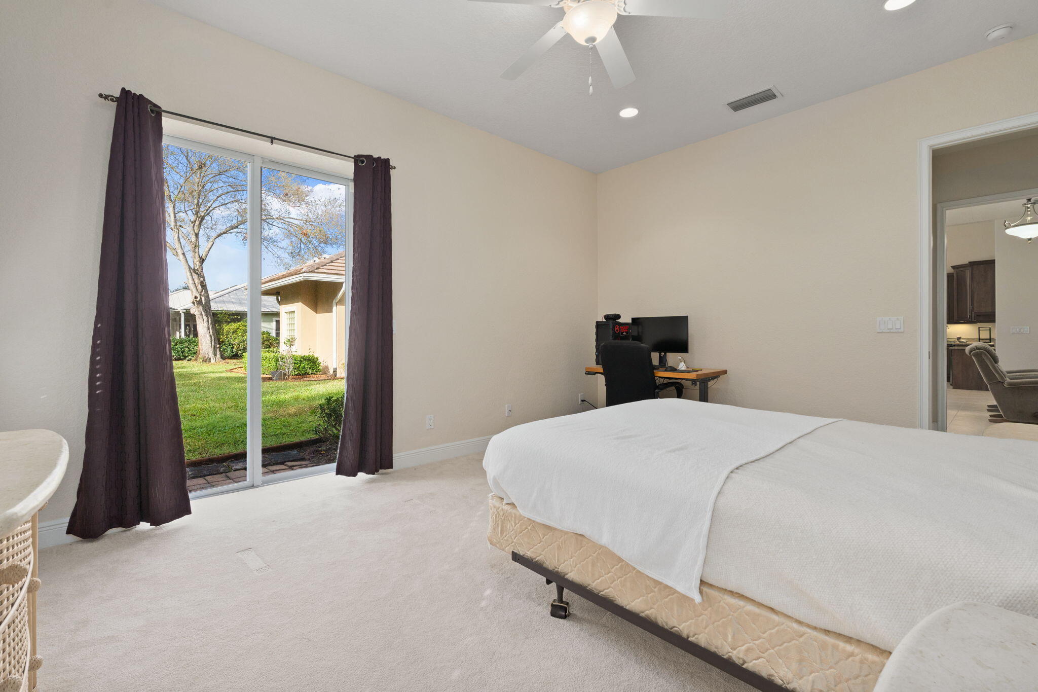 9523 Shadow Lane Fort Pierce, FL 34951 - Photo 28 of 32 a bedroom with a balcony a bed and a window