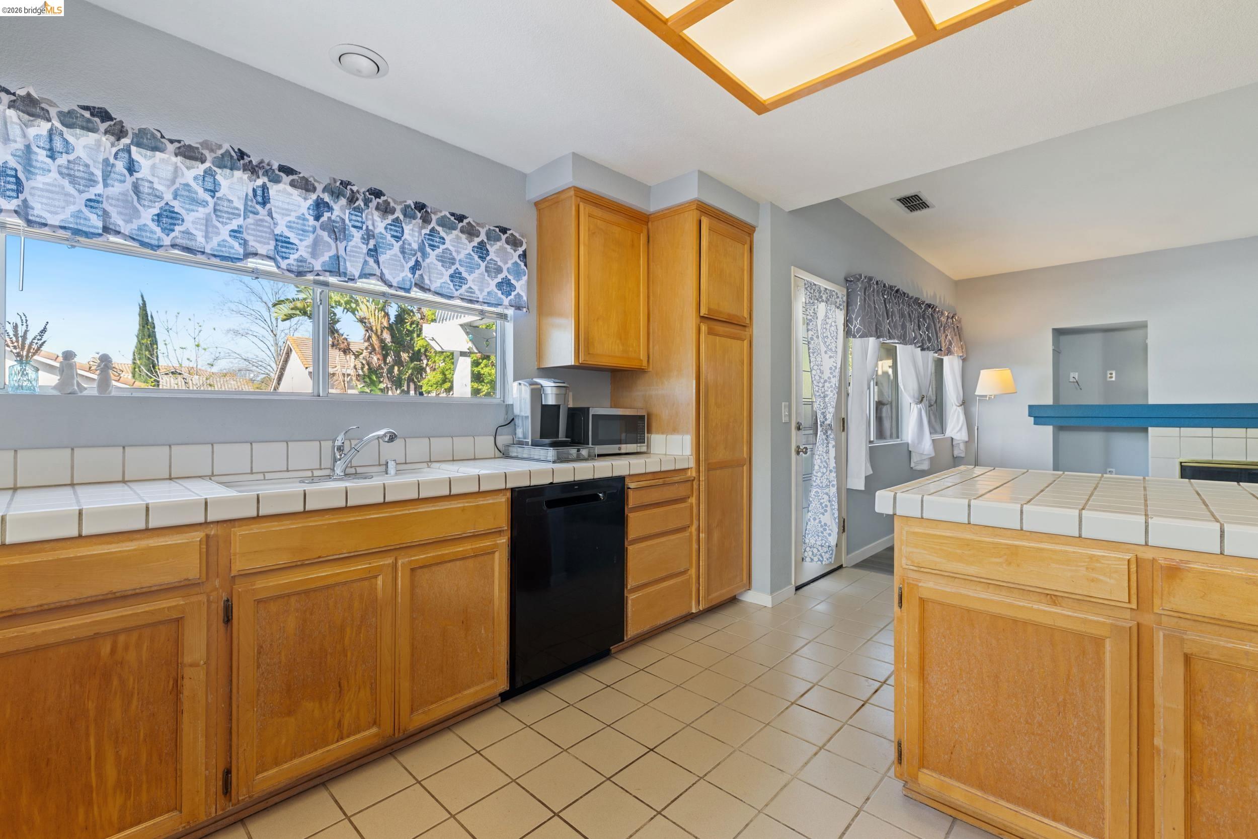 4924 Stirrup Way Antioch, CA 94531 - Photo 11 of 40 a kitchen with stainless steel appliances a stove a sink and a refrigerator